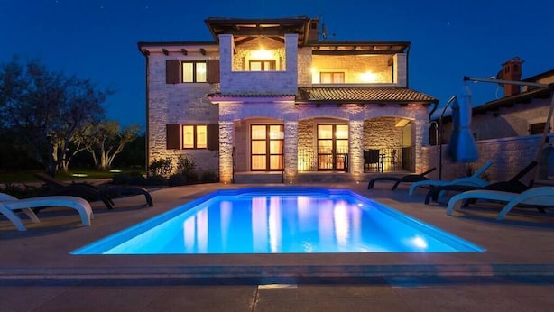 A two-story house with a swimming pool in the foreground, stone exterior, and multiple windows. - Beautiful villa with pool for 8 near the beach (Tar-Vabriga)