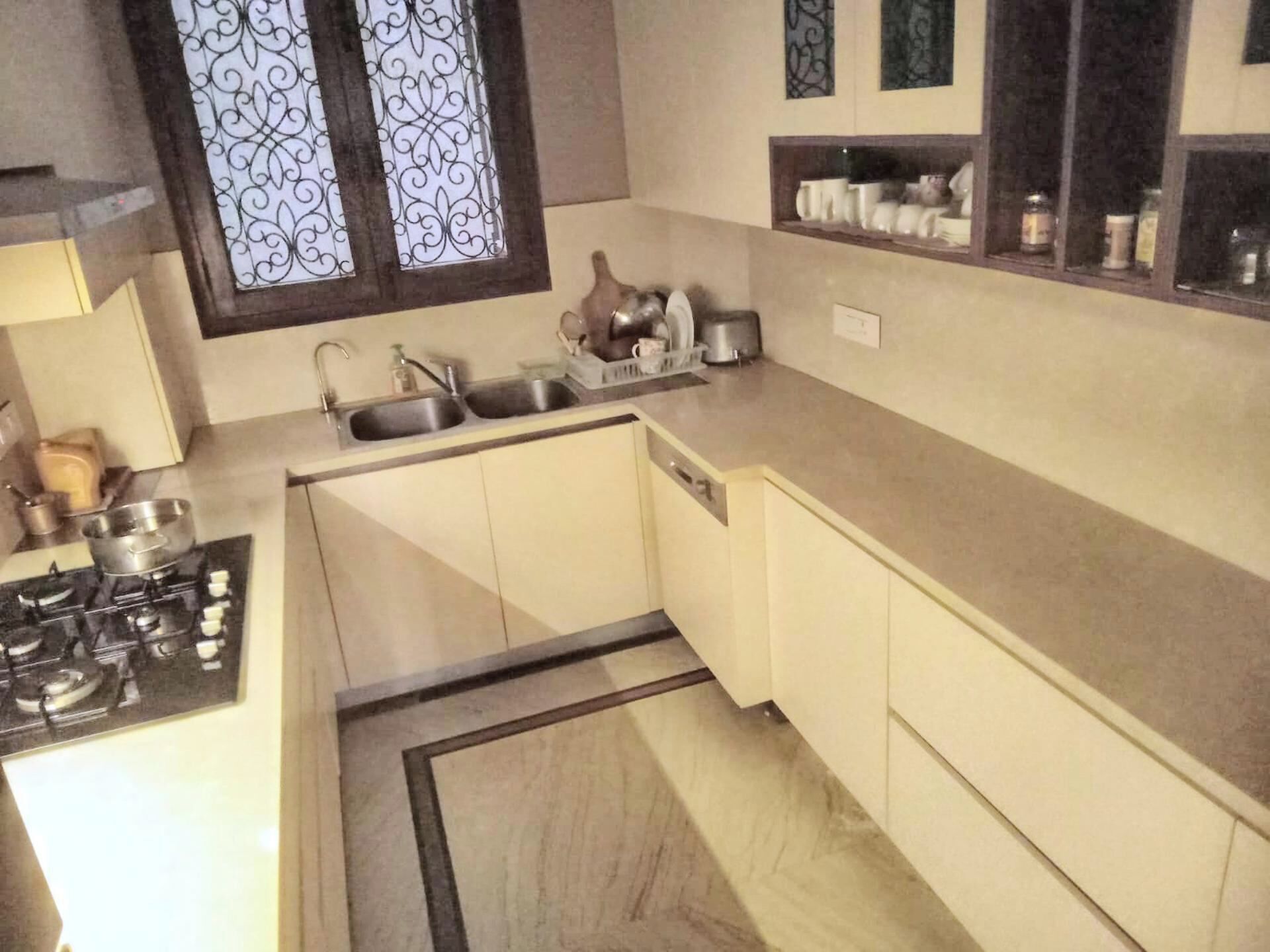 Cocina compacta con estufa a gas, dos fregaderos y una pequeña encimera.