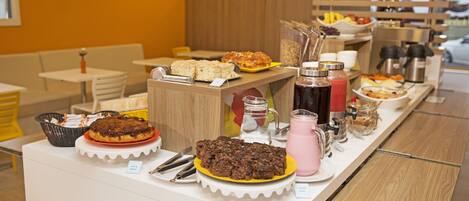 A buffet with various food items and beverages.