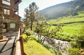 Situated on a hillside, this lodge offers breathtaking views of a lush valley and a flowing river.