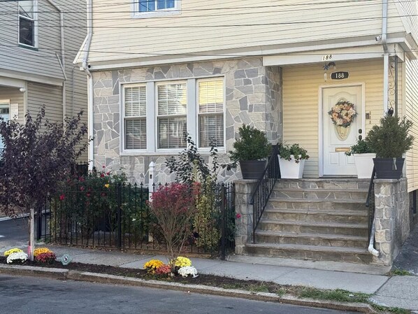 Stunning two-story home with a charming front porch and beautifully landscaped gardens.