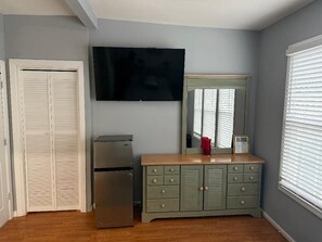 Enjoy a comfortable stay in this well-appointed room featuring a cabinet, flat-screen TV, and window with blinds.
