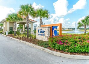 A hotel entrance with a sign reading "The Cove Apartments & Suites."