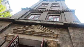 A building with a brick facade, multiple windows, and a central decorative element.