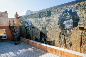A mural with geometric patterns and a staircase.