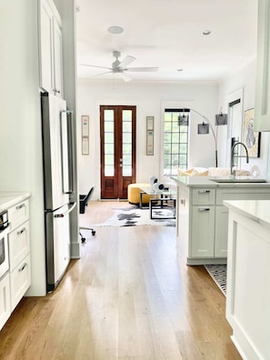 At top of stairs to house is the kitchen and living room space