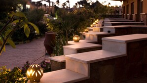 A series of outdoor steps leading up to a building, with decorative lighting and plants around. - Silver Beach Boutique Hotel (El Quseir)