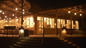 A building with a covered outdoor area, steps leading to the entrance, and multiple light fixtures. - Silver Beach Boutique Hotel (El Quseir)