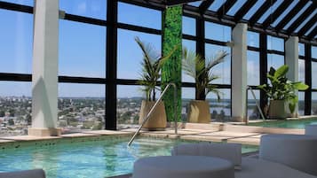 Indoor pool, open 9:00 AM to 9:00 PM, pool loungers
