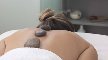 Experience a soothing massage on a comfortable table, surrounded by calming elements.