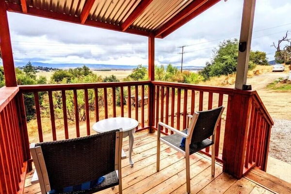 Porch with chairs facing an amazing view of the valley