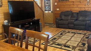 A wooden interior with a TV, sofa, dining table, and chairs. - Family Fun Villa - Very Clean (Warrens)