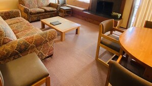 A cozy living room with a sofa set, a coffee table, and a fireplace. - Available 1 week only: 
 Prime ski week Feb 22 - March 1 Sunday - Sunday (Wilson)