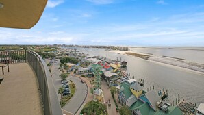 A coastal town with a marina, buildings with colorful roofs, and a clear view of the sea. - Emerald Grande ❤️❤️ 7th Floor Corner Unit 😎😎 Wrap Around Balcony 🐠🐠 EV Chargers 🦀🦀 (Destin)
