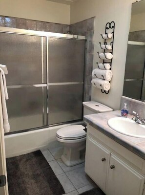 Combined shower/tub, hair dryer, towels, toilet paper