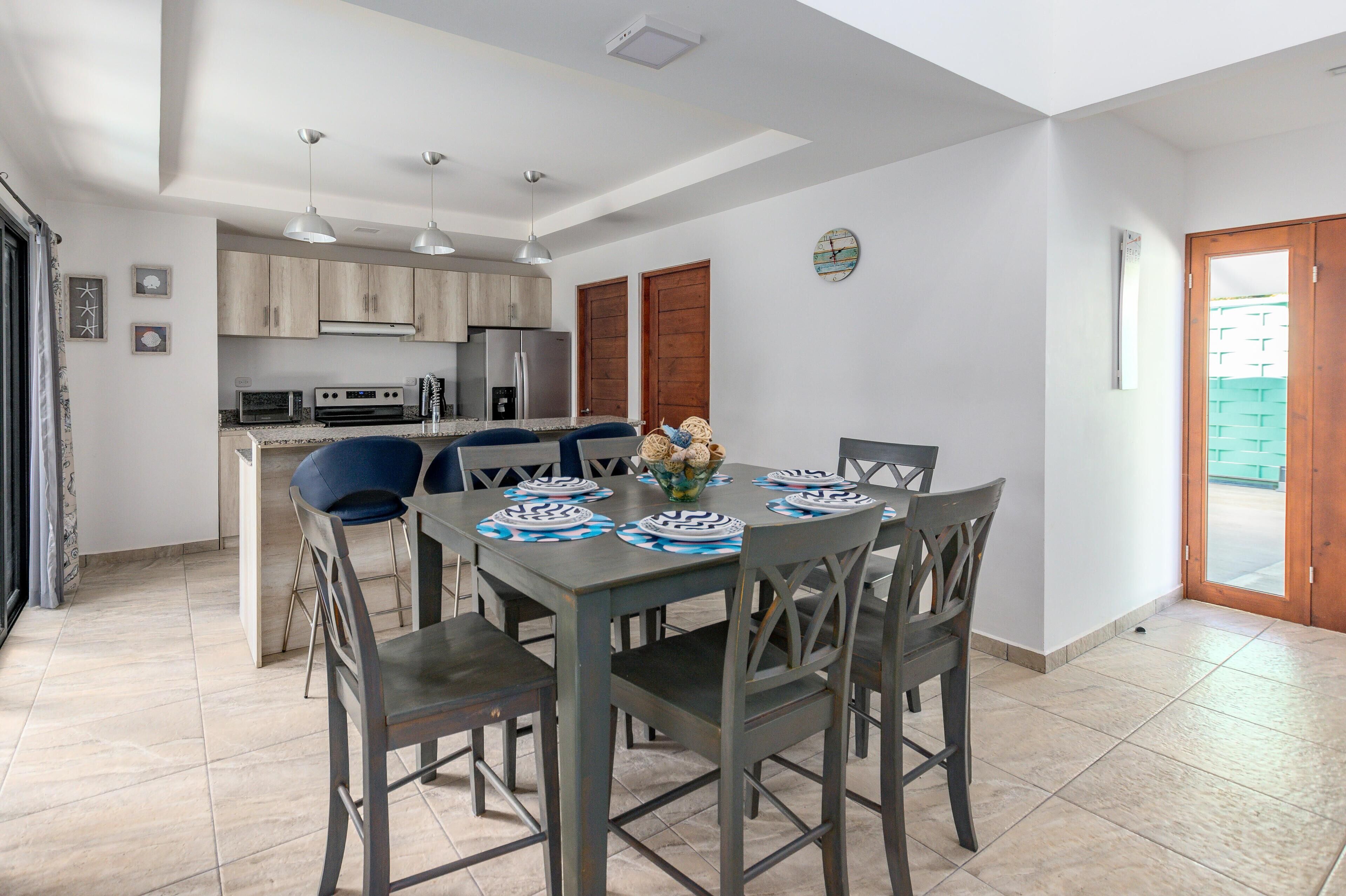 A modern kitchen with wooden cabinets, a built-in oven, and a microwave.