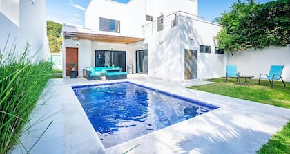 Ultramodern Townhome with an Inviting Coastal Design and Lush Outdoor Oasis with a Private Pool