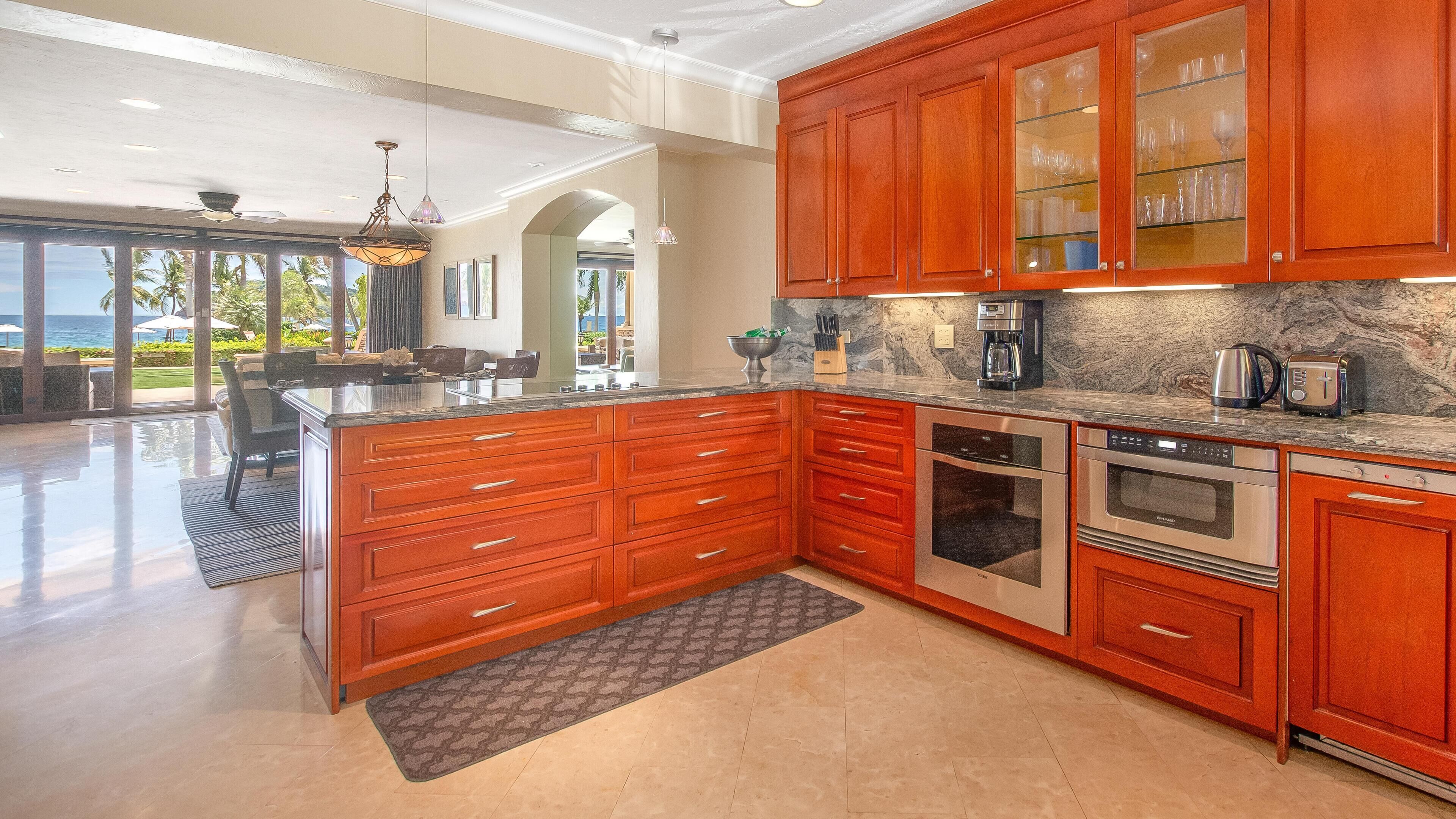 A spacious kitchen with wooden cabinets, stainless steel appliances, and a large island.
