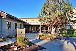 A building with a sign for 'Ridge Sports & Spa' and a sign for 'Sports Center & Spa' in front. - Hot Tub, 2 blocks to Splash Pool, Sleeps 8, on the creek (Redmond)
