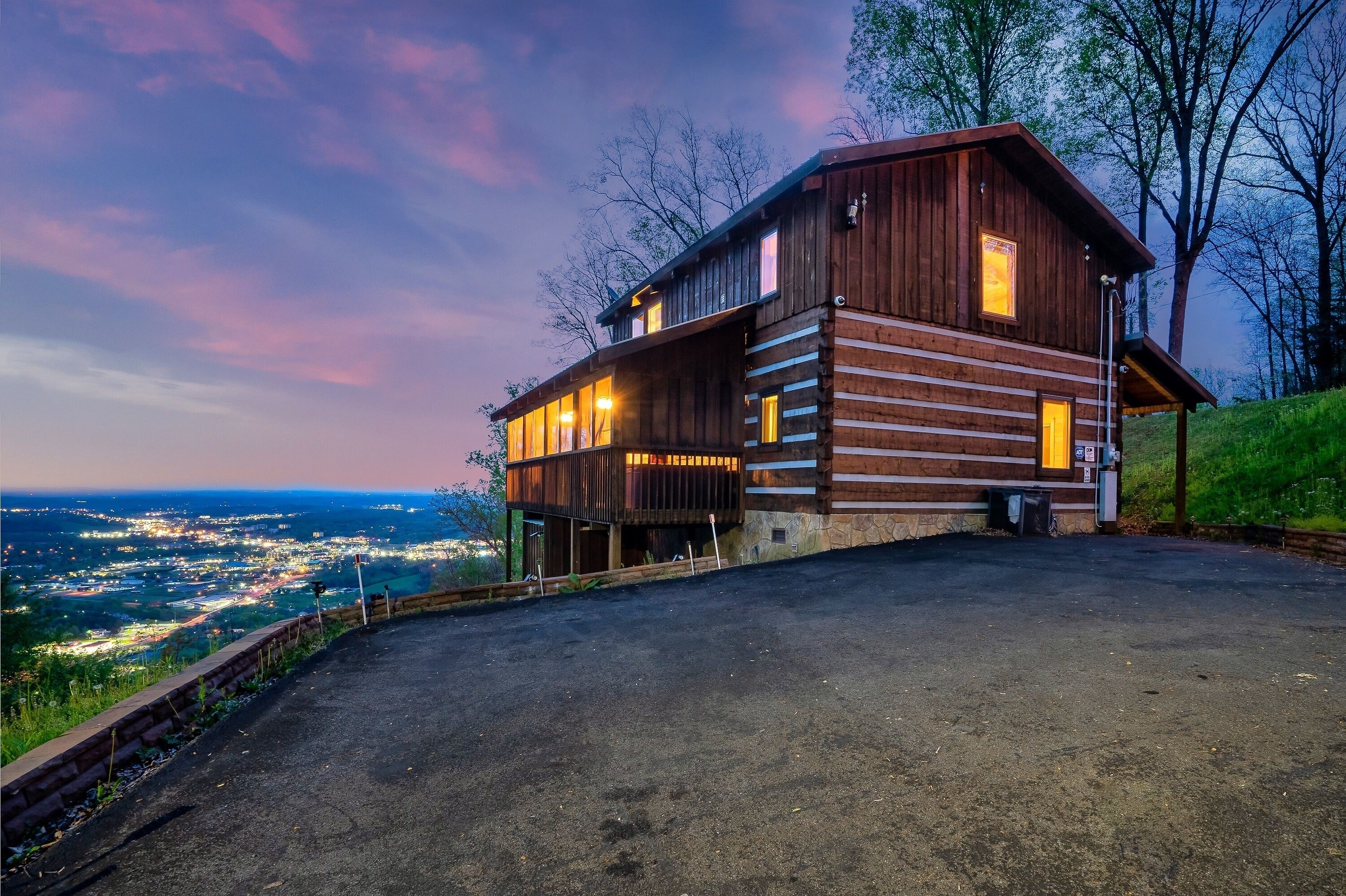 A wooden cabin with a balcony overlooking a scenic view.