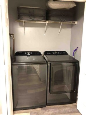 A laundry room with two front-loading washing machines and a shelf above them. - RARE - 2 miles to Dollywood - Arcades & Much More (Sevierville)