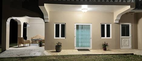 A house with a balcony, a front door, and a small porch area.