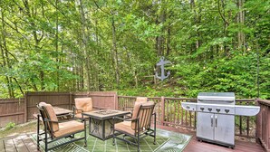 An outdoor deck with a grill, a table, and two chairs. - Rustic Adirondacks Home w/ Hot Tub & Lake Access! (Chestertown)