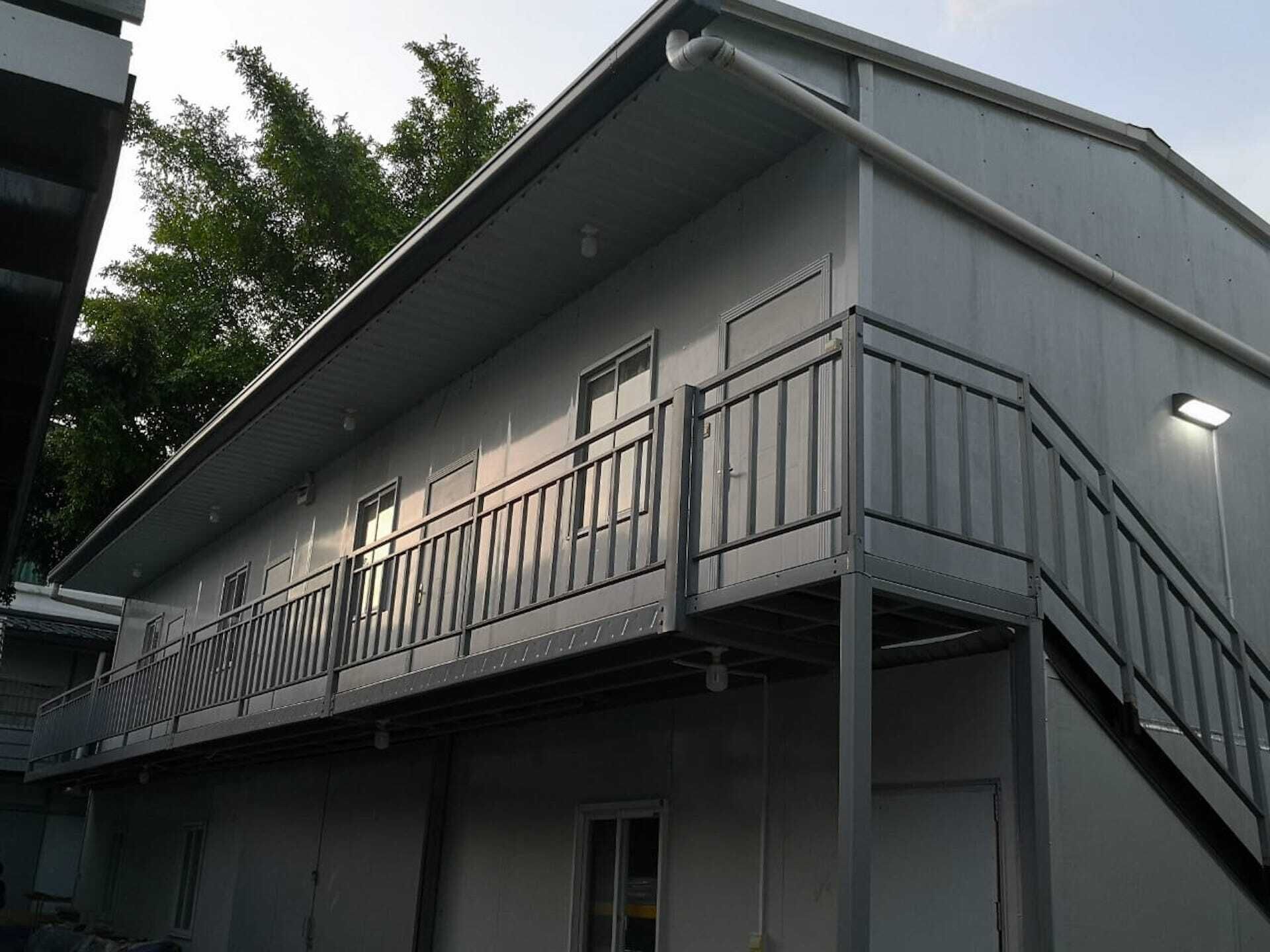 A two-story building with a balcony on the second floor.