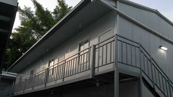 A two-story building with a balcony on the second floor.