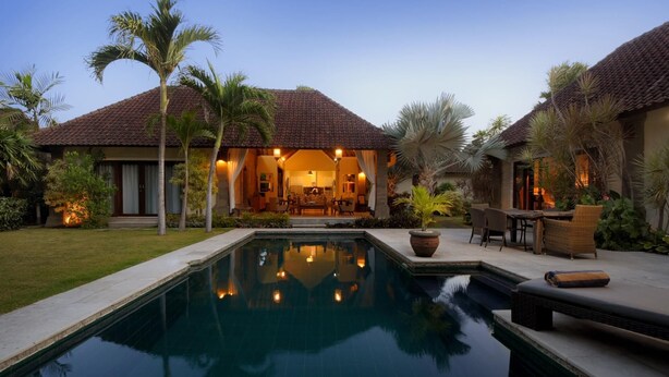 A resort with a swimming pool, outdoor seating, and a well-lit interior. - Spacious, 800sqm, Pool and Garden Retreat, Sanur Village (Sanur)