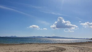 A beach with a clear sky, calm sea, and distant mountains. - Luxury Golf View 3Bed Penthouse, Sleeps 6, Balcony (Mar Menor Golf)