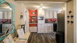 A compact kitchen with white cabinets, a microwave, and a coffee maker. - Crabbin Cabin - Spacious, Seasonal Riverside Home (Midway)