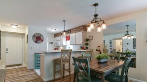 A modern kitchen with wooden flooring, a central island, and pendant lighting. - Southern Paradise - Resort Amenities - Close to Downtown and the Branson Landing (Branson)