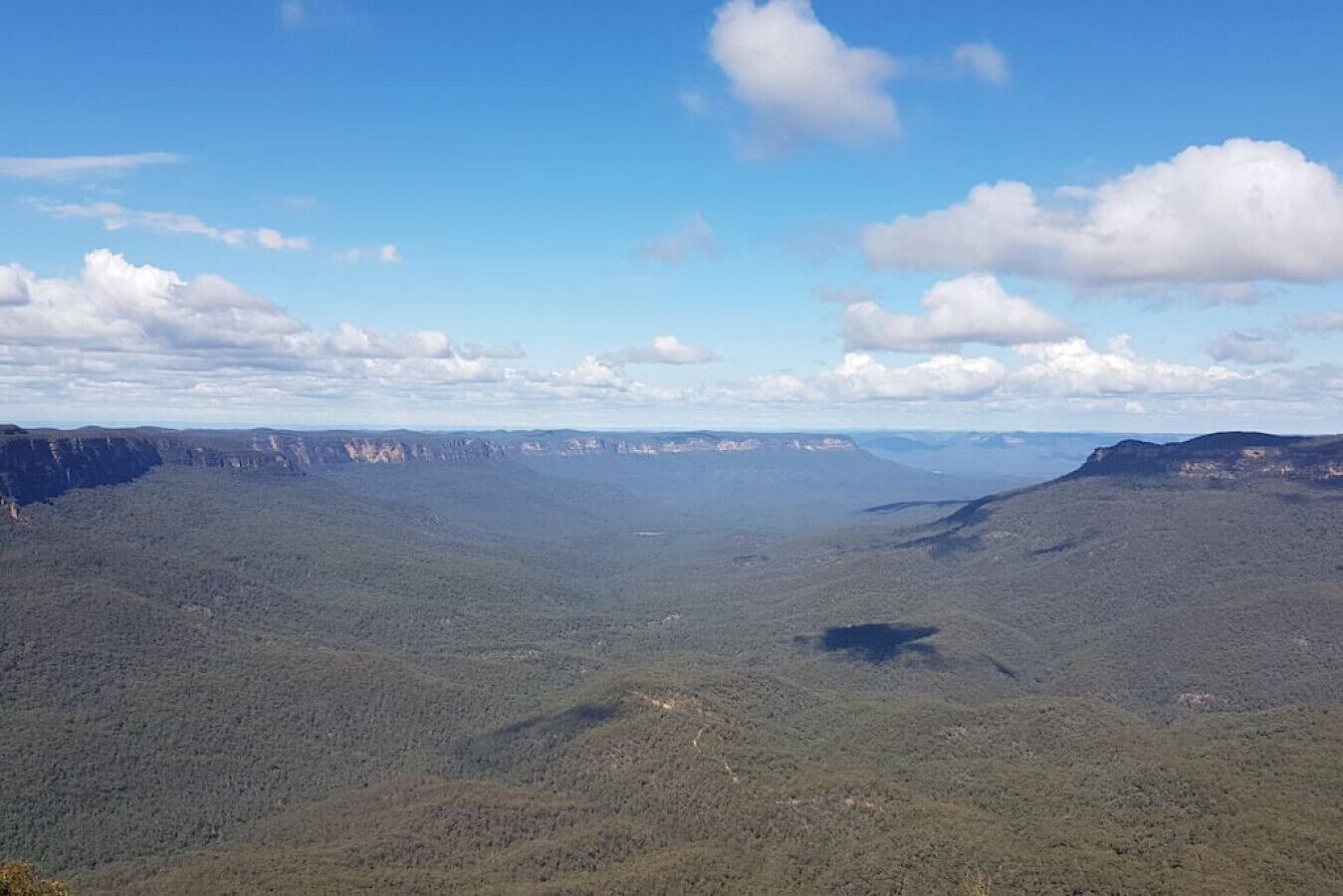 A vast canyon landscape with a clear sky.