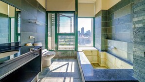 A modern bathroom with a large window, a bathtub, and a toilet. - Le Lu (Jiaoxi)