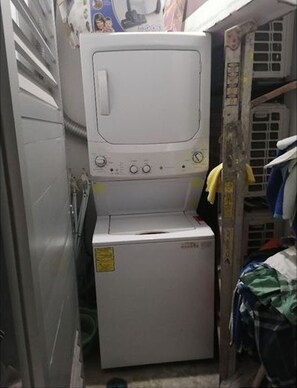 Compact laundry facilities feature a front-loading washer and dryer.