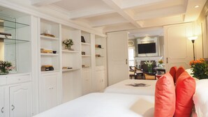 A hotel room with two beds, white walls, and a television mounted on the wall. - Pasaje de Hamburgo By The Local Way (Mexico City)