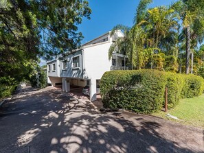 Ein Wohnhaus mit Auffahrt, Garage und gepflegtem Heckenstreifen.