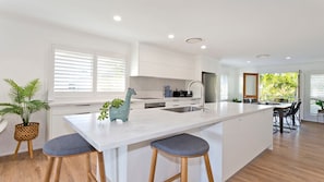 Enjoy cooking in this well-equipped kitchen with a central island and stainless steel appliances.