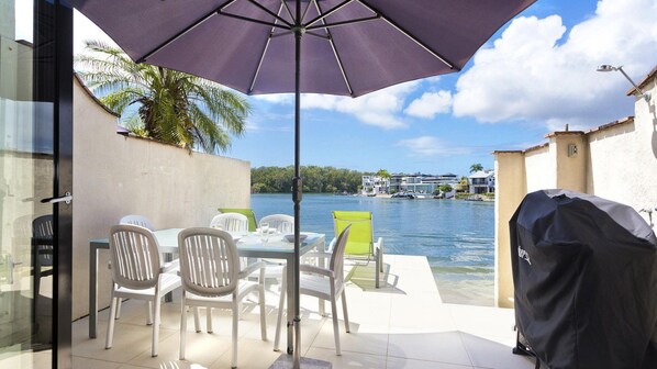 Enjoy al fresco dining with a view of the water and distant shoreline from this outdoor patio.