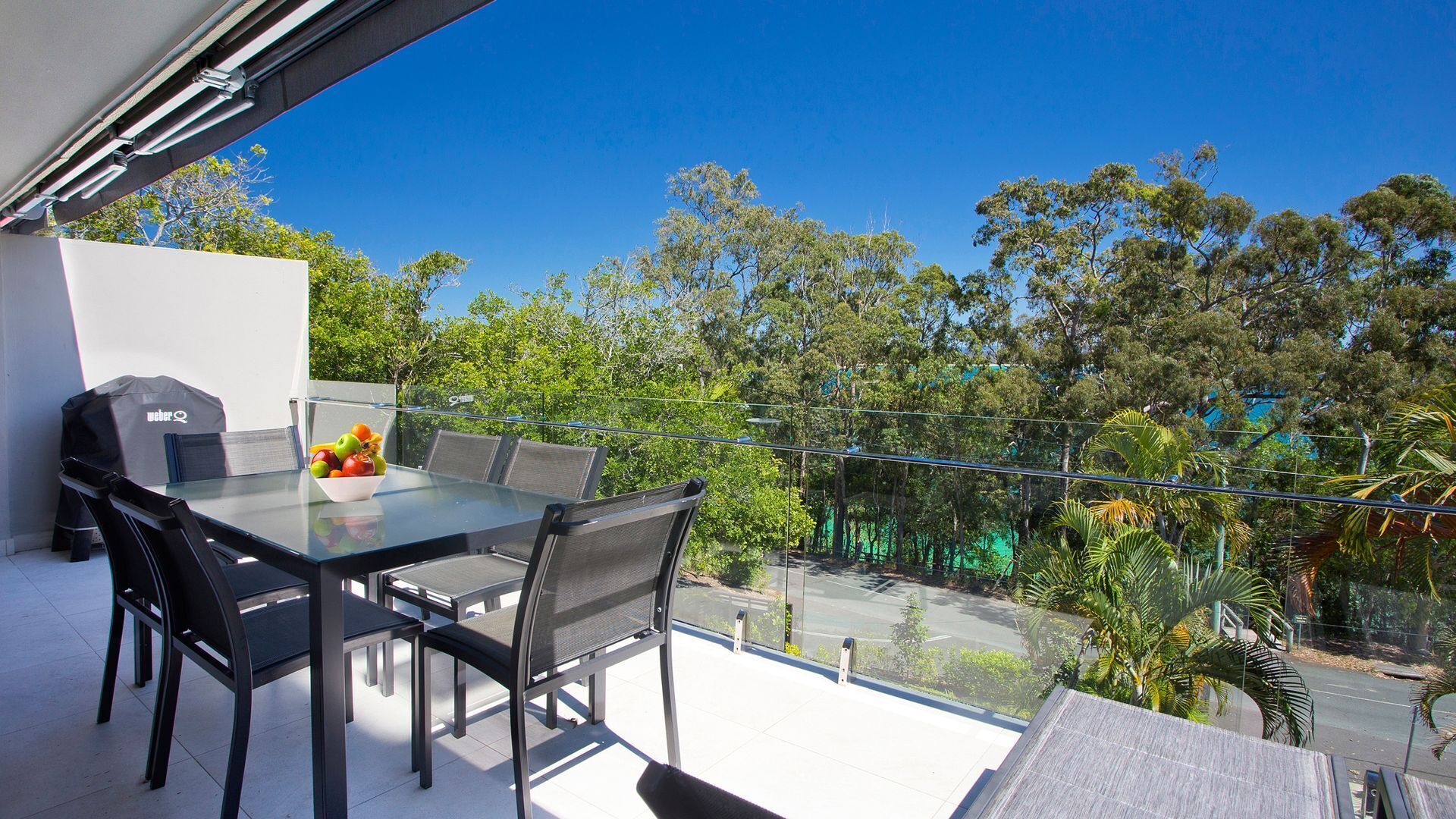 Relax by the pool whilst enjoying the landscaped garden and Laguna Bay views — image 4