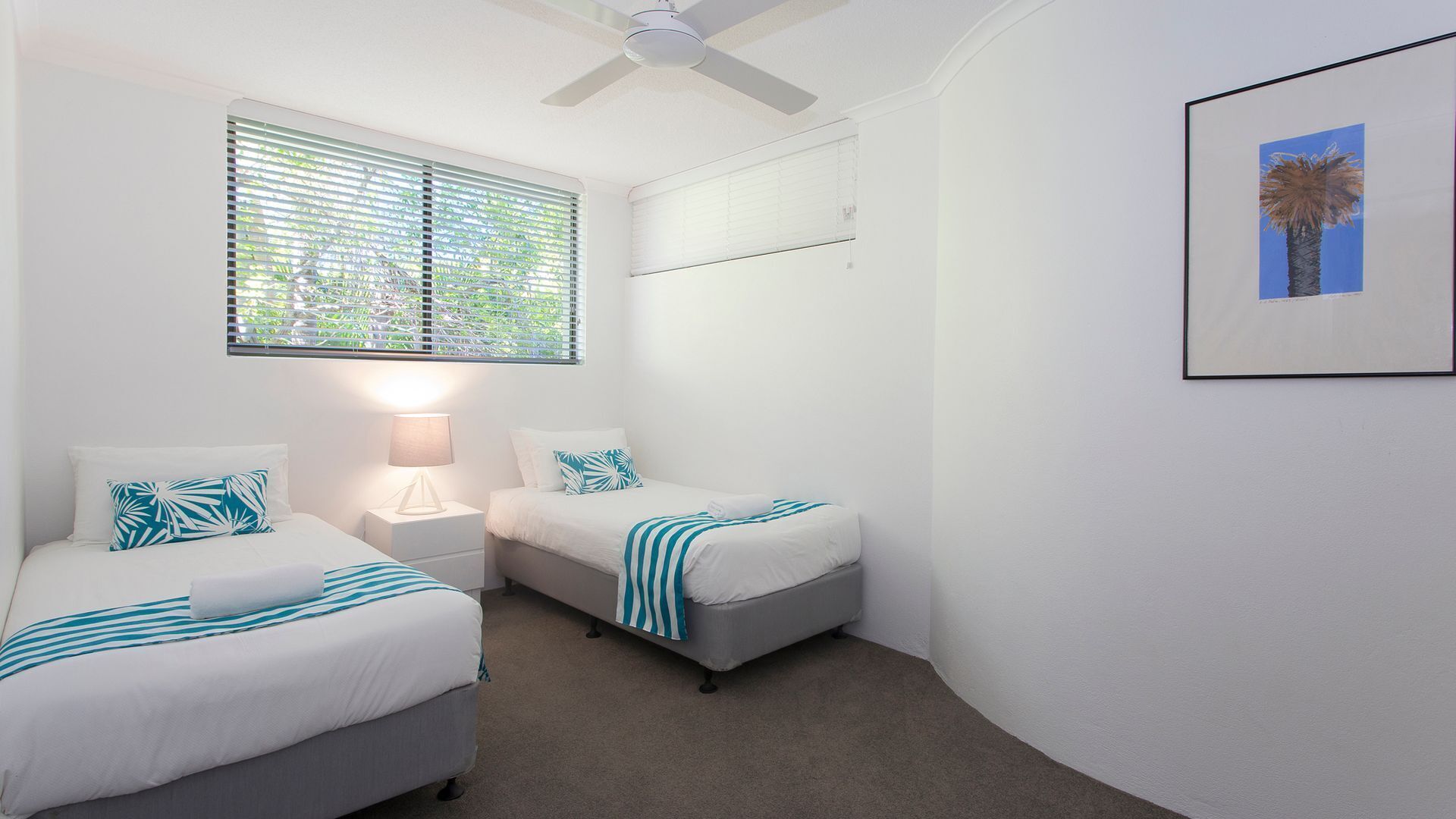 Relax by the pool whilst enjoying the landscaped garden and Laguna Bay views — image 11