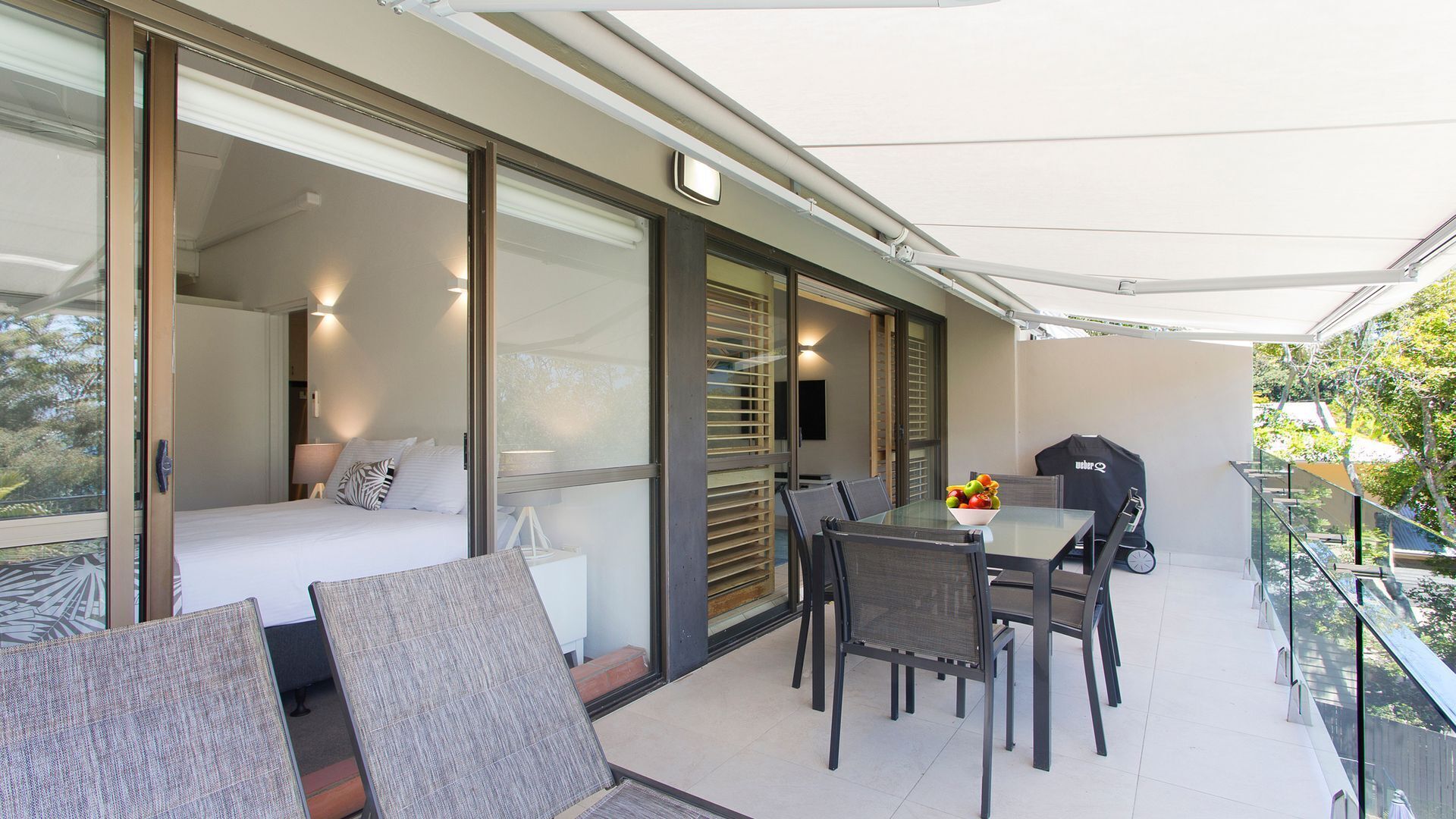 Relax by the pool whilst enjoying the landscaped garden and Laguna Bay views — image 12