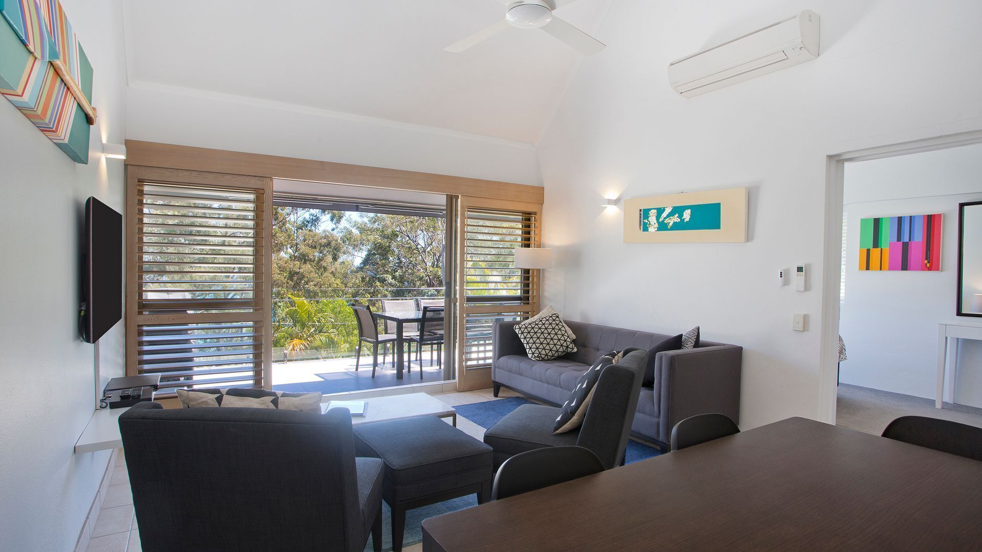 Relax by the pool whilst enjoying the landscaped garden and Laguna Bay views — image 7