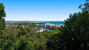 A coastal resort with multiple buildings, a marina, and lush greenery.