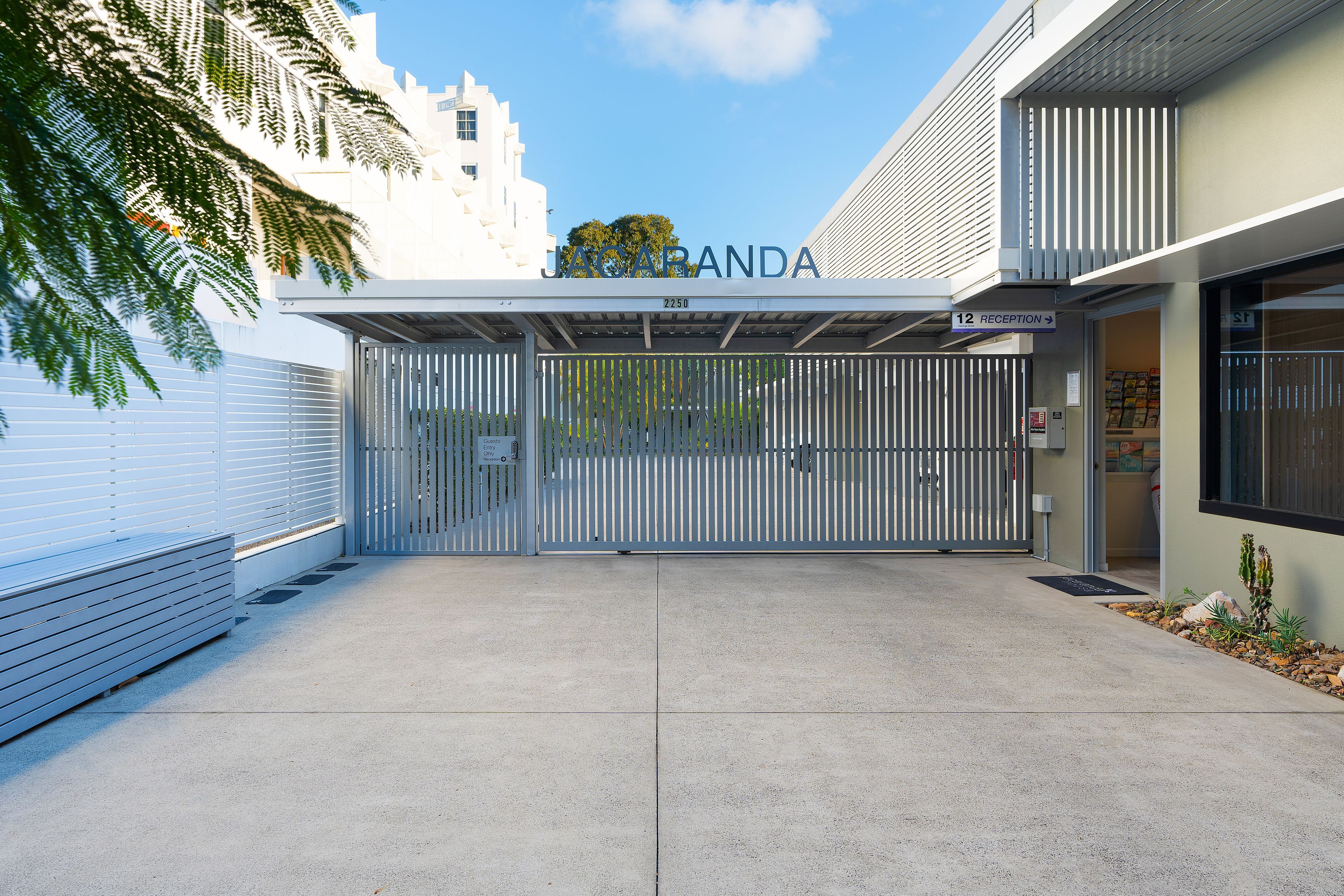 A gated entrance to a building with a sign reading 'JACARANDA'.