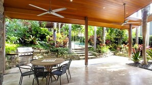 Relax in the serene outdoor patio, complete with a grill and comfortable seating for four.