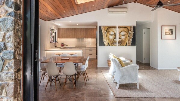 Enjoy meals in the dining area with a wooden table and comfortable chairs.