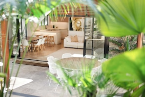 A modern interior with a dining area, a living space, and a kitchen.