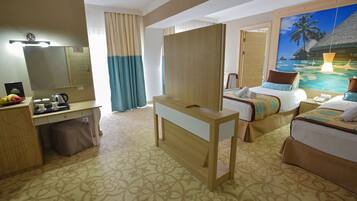 A hotel room with a bed, a desk, a mirror, a wardrobe, and a painting of a tropical beach.